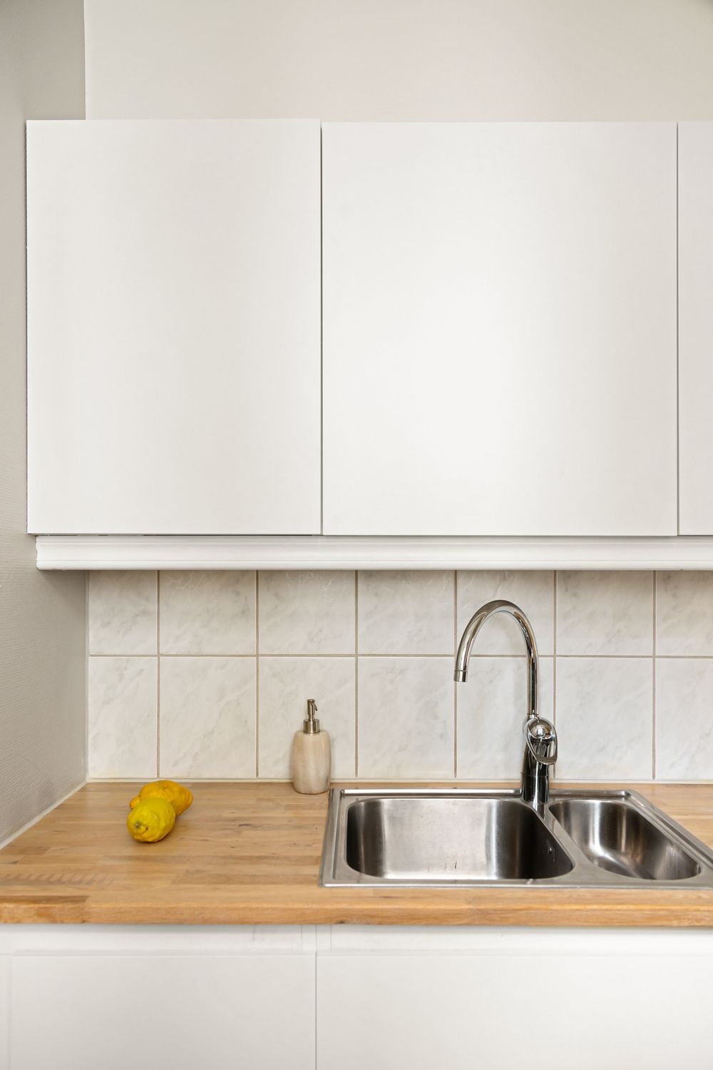 Clean kitchen sink and mixer tap after work is finished